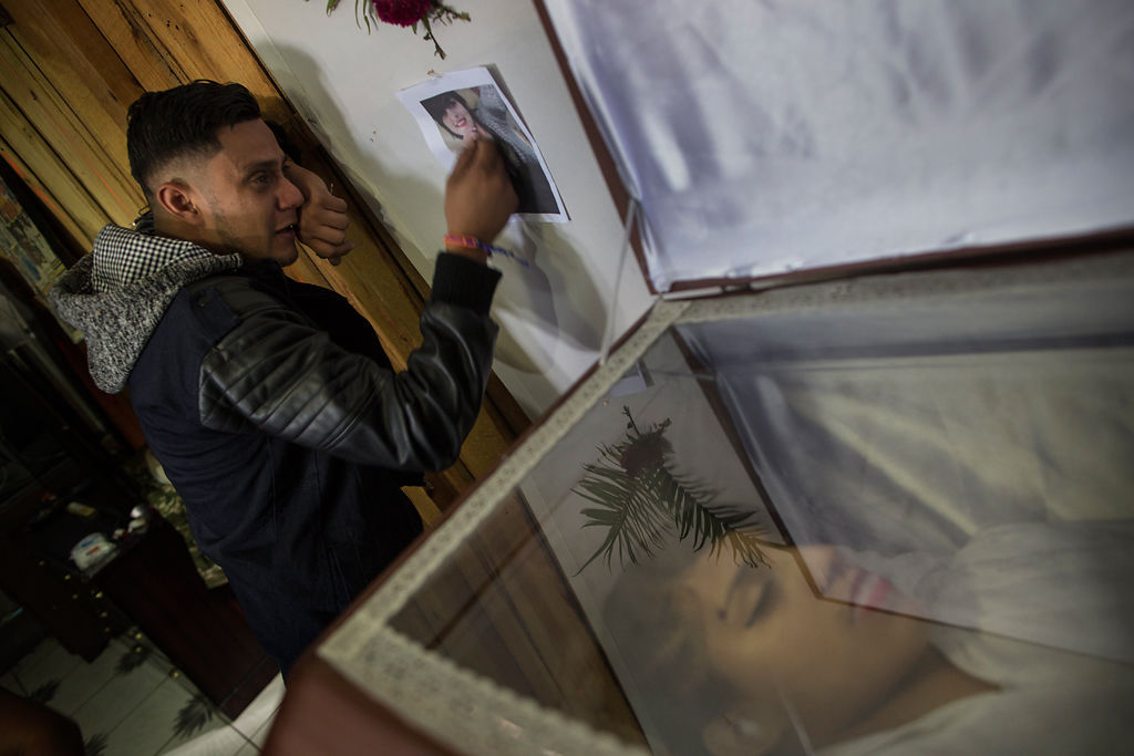 Rudy Fonseca, 29, cries standing next to the coffin containing the remains of his sister Kimberly Dayana
